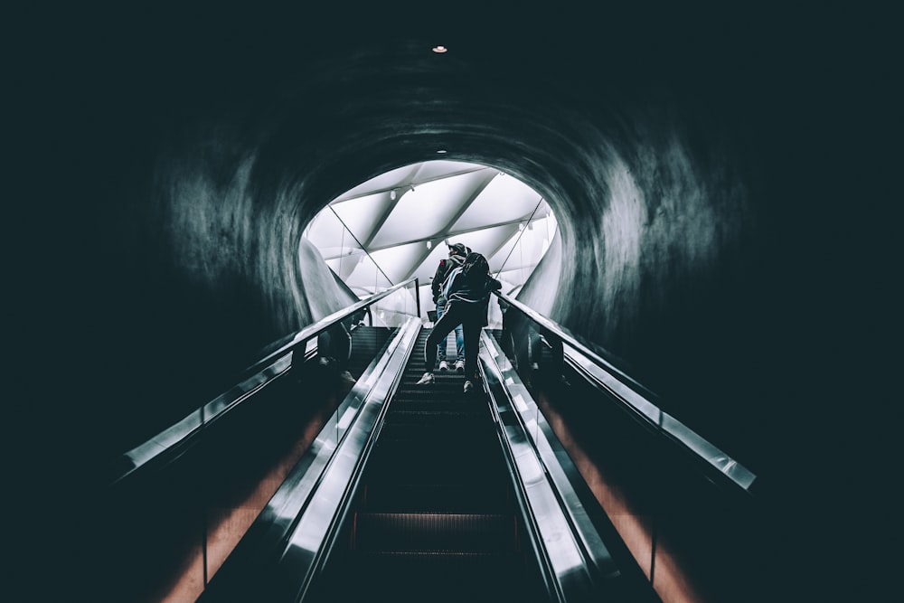 person standing on escalator