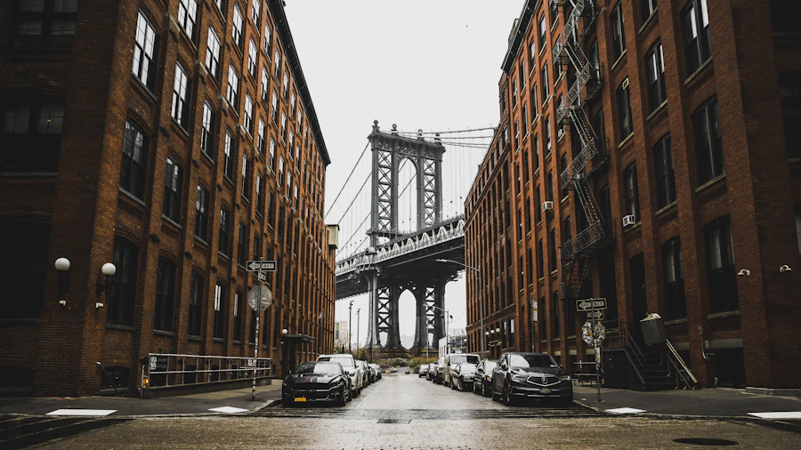 The Manhattan Bridge framed by red brick buildings in Brooklyn