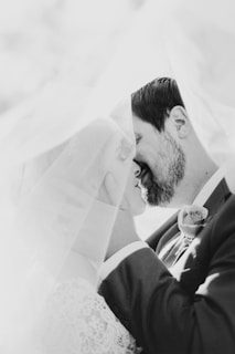bride and groom kissing under veil
