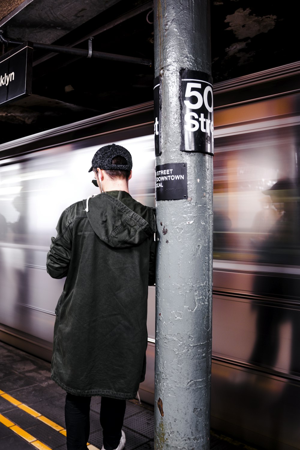 man leaning on the post