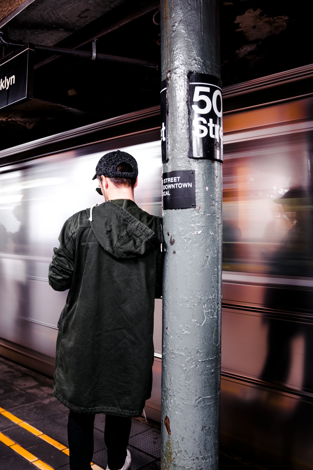 man leaning on the post