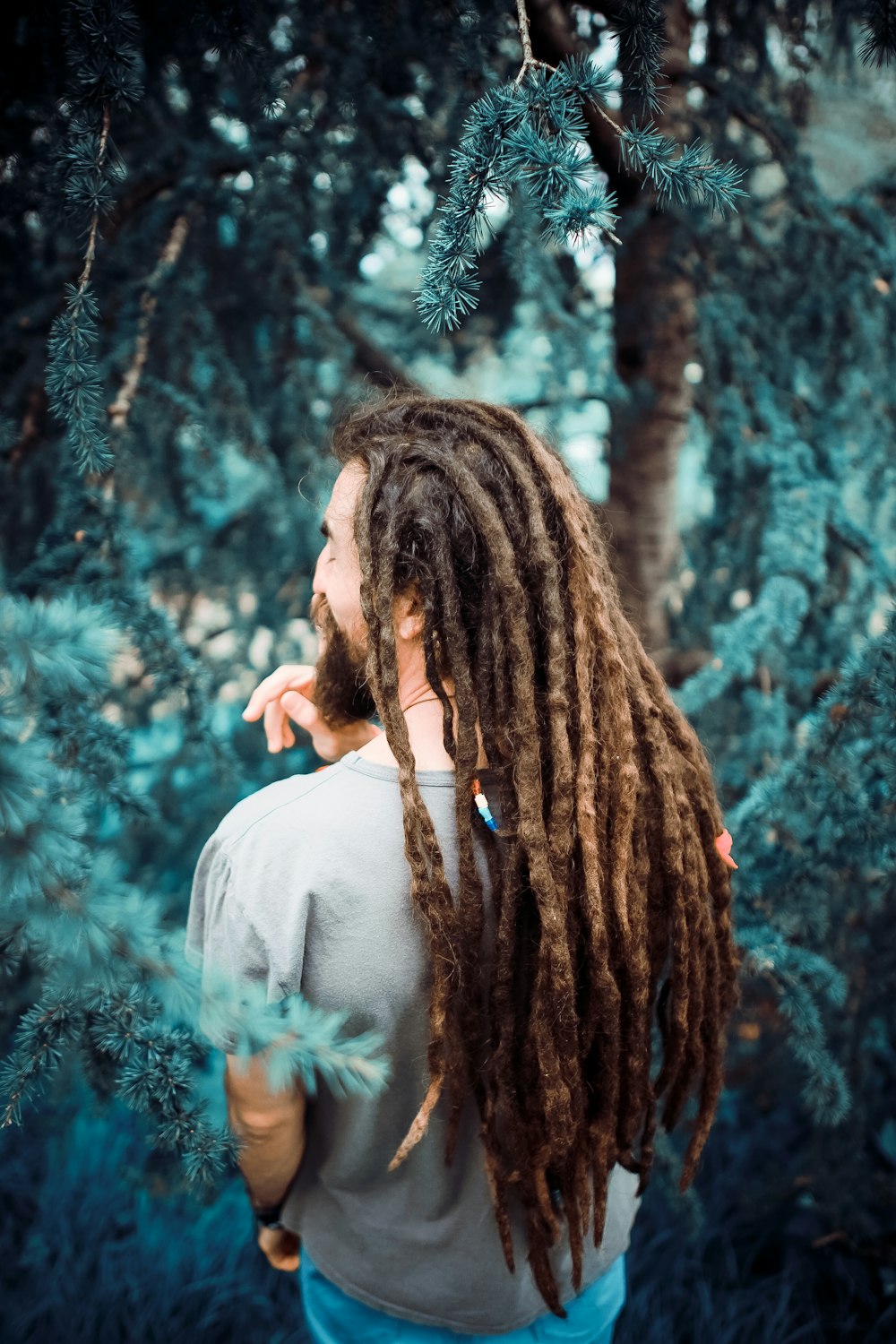 man standing in front of tree