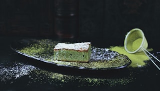 green and brown sponge cake on black oval plate