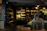 Cozy interior of Lerio's épicerie at night with warm bordeaux lighting.