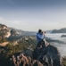 man on top of mountain taking pictures