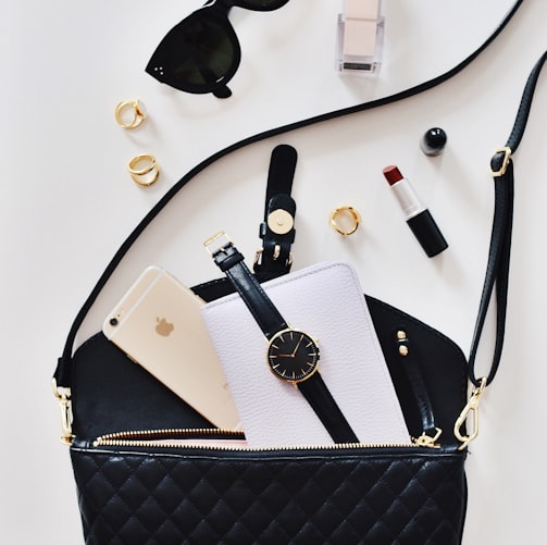 women's sunglasses and black bag with watch and iPhone 6