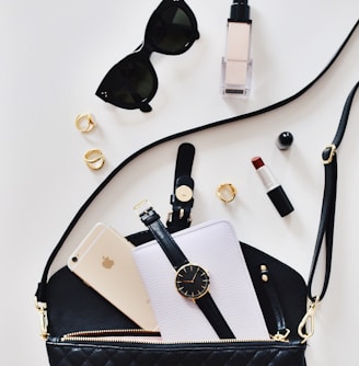 women's sunglasses and black bag with watch and iPhone 6