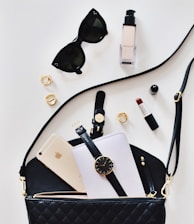 women's sunglasses and black bag with watch and iPhone 6