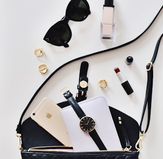 women's sunglasses and black bag with watch and iPhone 6