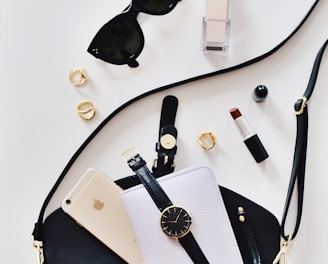 women's sunglasses and black bag with watch and iPhone 6