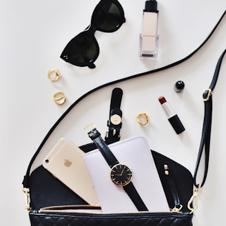 women's sunglasses and black bag with watch and iPhone 6