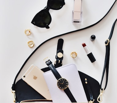 women's sunglasses and black bag with watch and iPhone 6