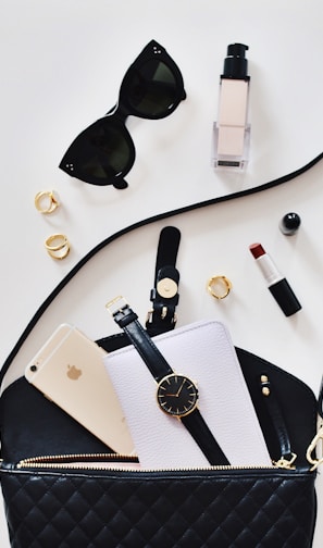 women's sunglasses and black bag with watch and iPhone 6