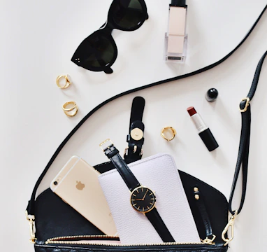 women's sunglasses and black bag with watch and iPhone 6
