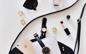 women's sunglasses and black bag with watch and iPhone 6