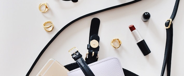 women's sunglasses and black bag with watch and iPhone 6