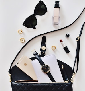 women's sunglasses and black bag with watch and iPhone 6