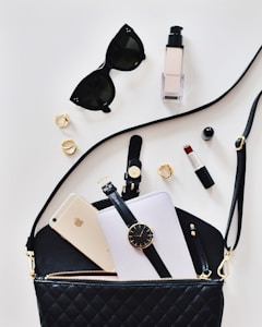 women's sunglasses and black bag with watch and iPhone 6