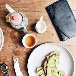 black leather long wallet beside plate