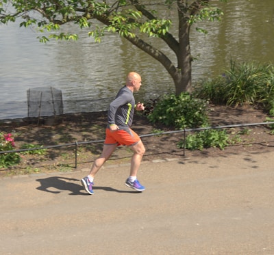 A man jogging along a scenic trail, embodying vitality and energy.