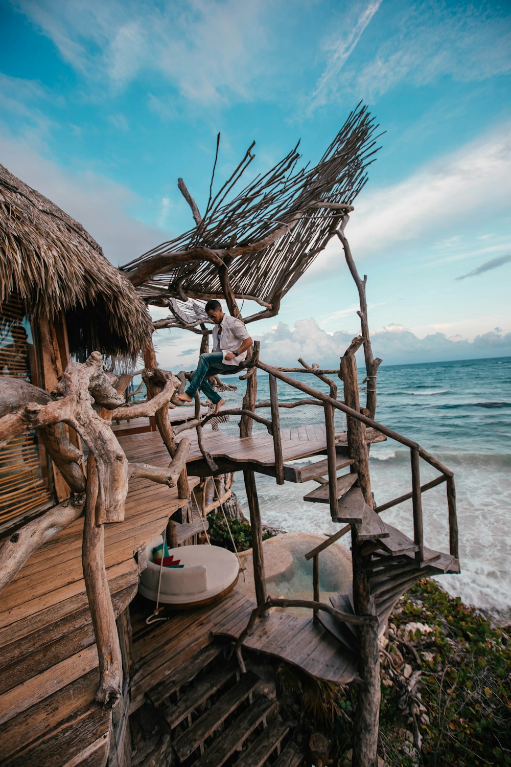 person sitting near ocean during daytime