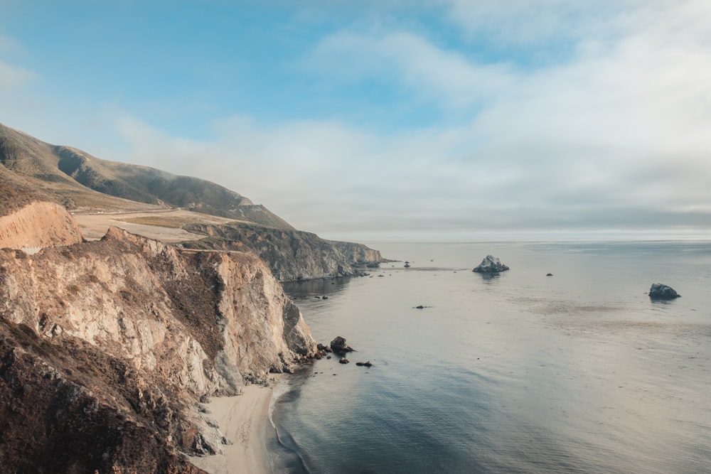 gray and brown cliff near the ocean