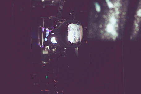 Close-up of a modern video projector casting a sharp image in a festive indoor setting.