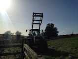 Outdoor scene showing a tractor ready after maintenance under a bright sky.