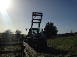 A sturdy, well-maintained tractor displayed in a sunny field.