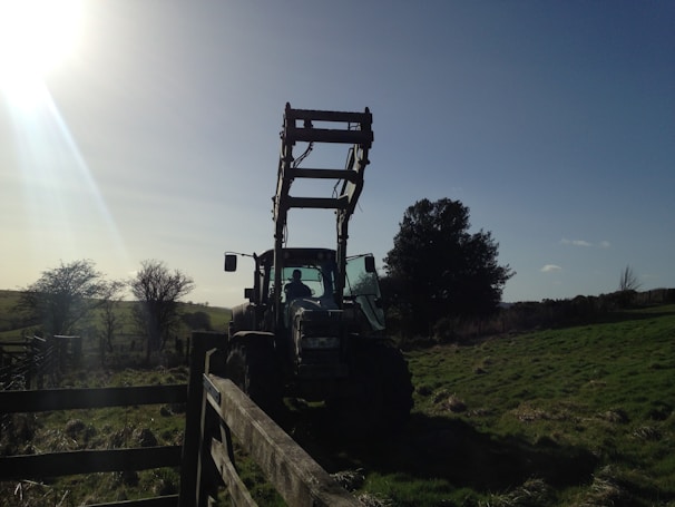 A farmer inspecting a modern tractor in a sunny field near Sinop.