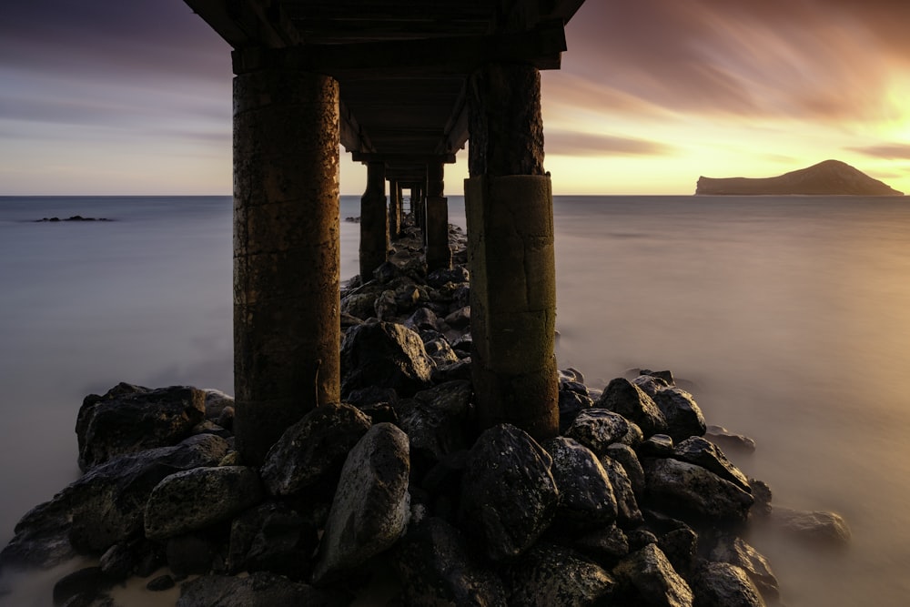 brown dock in body of water