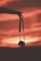 A silhouette of a hand holding a camera by its strap against a vibrant sunset sky. The sky features warm hues of red, orange, and pink blending together, creating a dramatic and peaceful atmosphere. The outline of the camera adds a sense of storytelling to the scene.