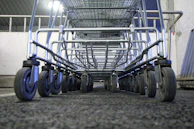 Close-up of sturdy metal supermarket gondola racks filled with goods
