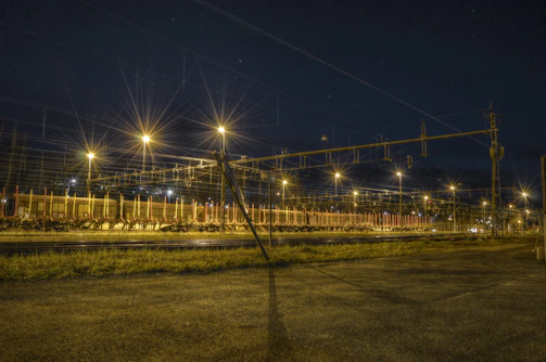 A night shot of a Swifttrack fleet lined up ready for dispatch under stadium lights.