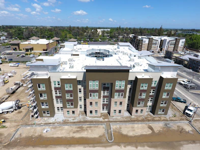 Aerial shot of a modern residential property with a clear blue sky backdrop.