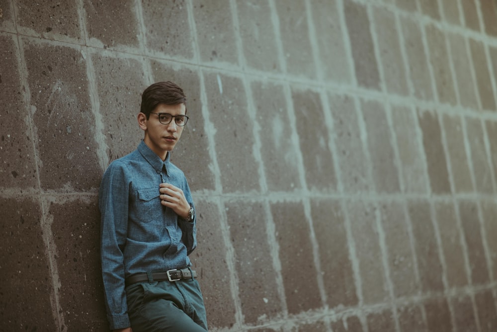 man leaning on wall