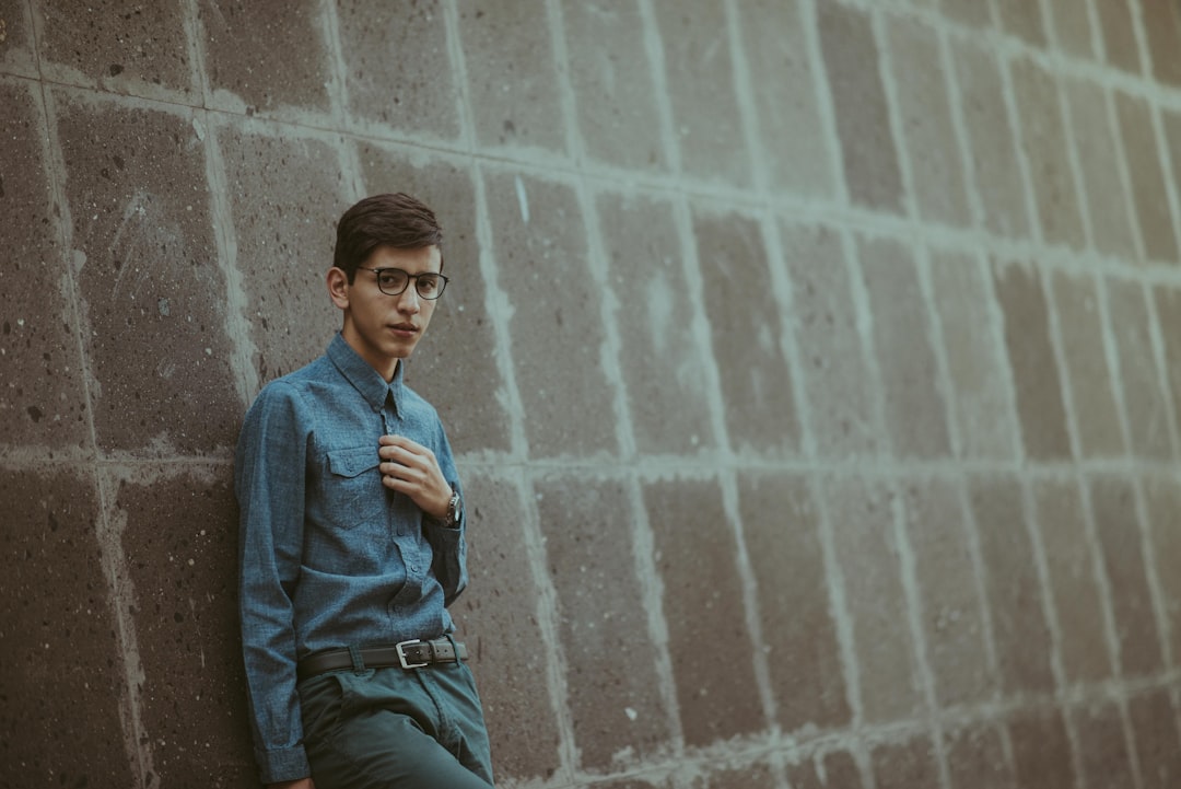 man leaning on wall