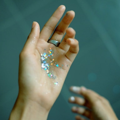 person showing hands with glitters