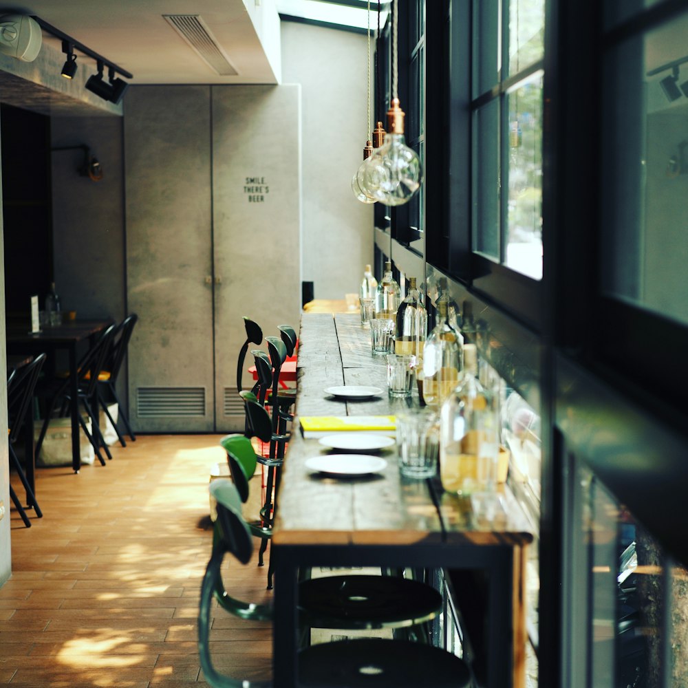 green metal bar stools on bar