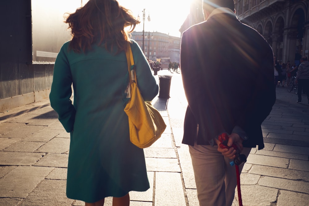 woman and man walking near building