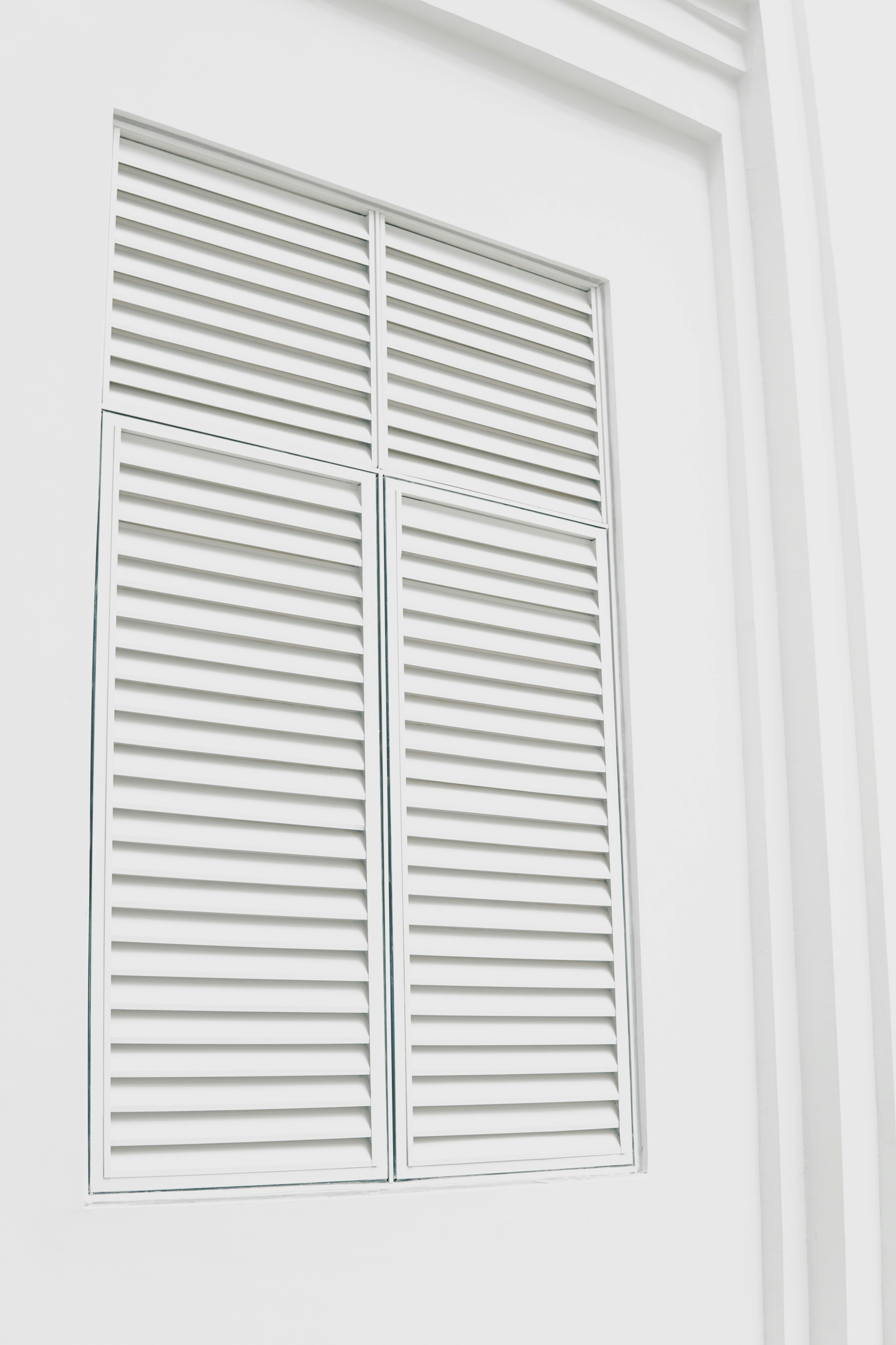 white wooden louvered door