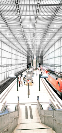 people standing in front of red train