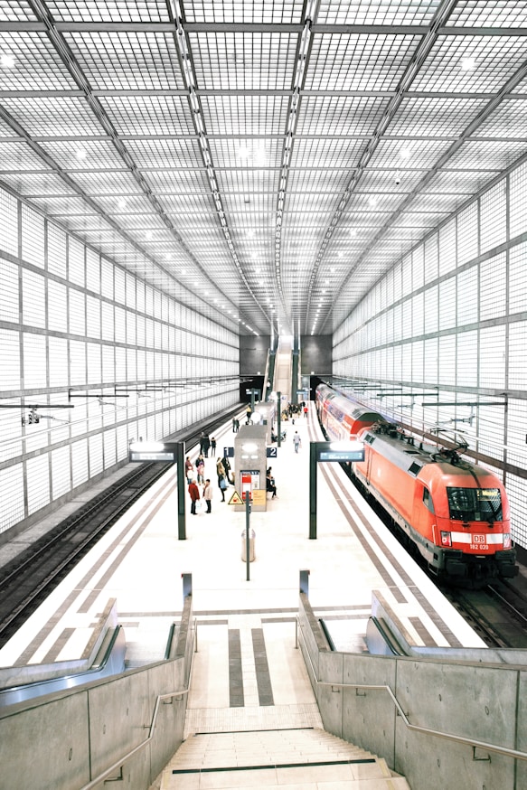 people standing in front of red train