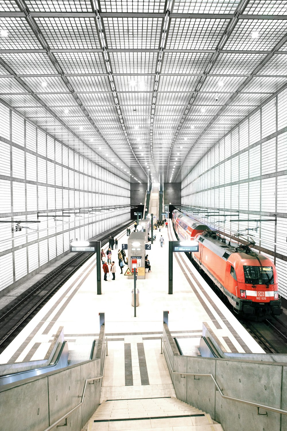 people standing in front of red train