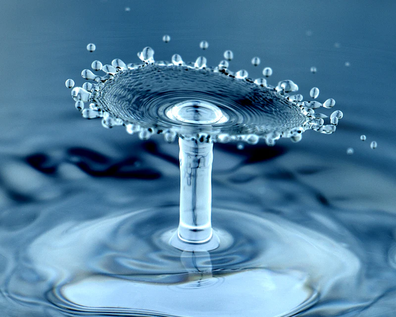 Macro photograph of a water droplet impact, representing precise water treatment