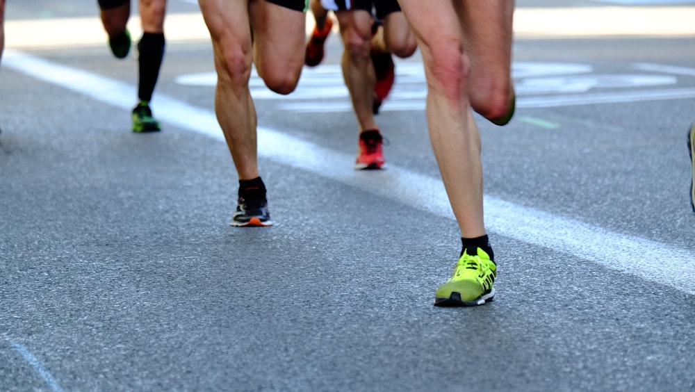 A shot of people's feet as they run on pavement.