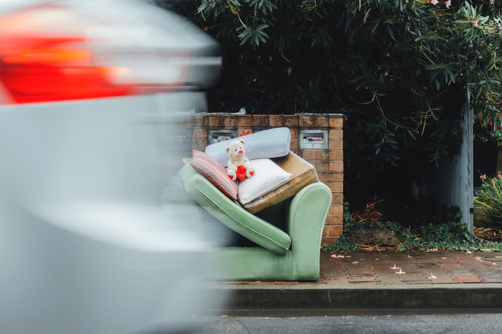 white bear plush on sofa chair beside road