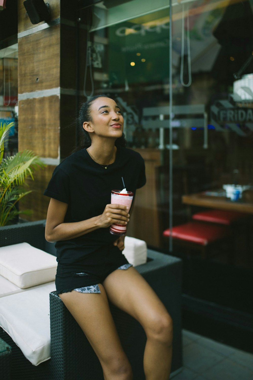 woman holding shake cup