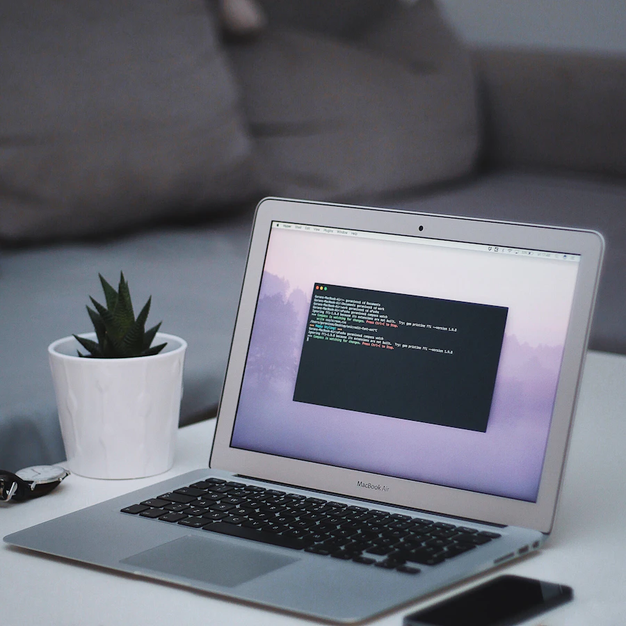A clean, minimal workspace with a laptop open to a code editor