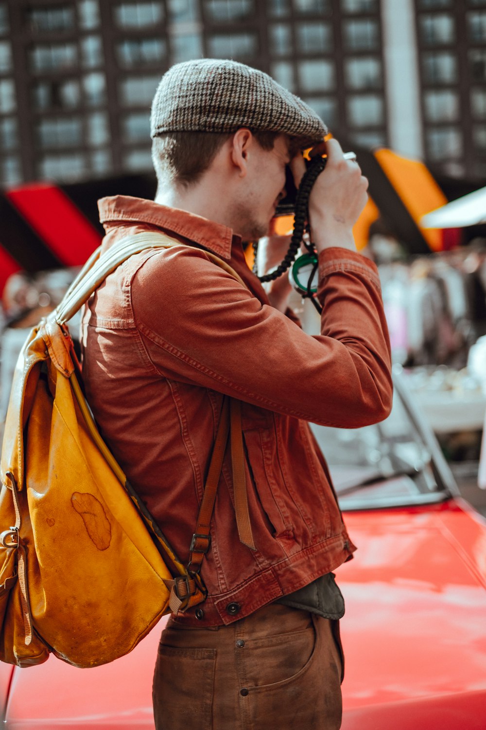 man taking photo near building